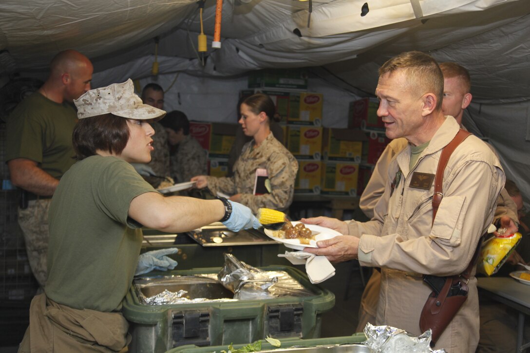 Lance Cpl. Olivia Ponce serves Maj. Gen. Jon M. Davis chow at the Marine Medium Tiltrotor Squadron 264 mess hall at Camp Bastion Afghanistan, April 22. Davis, the 2nd Marine Aircraft Wing commanding general, visited the Marine aviation squadrons on both Camp Leatherneck and Camp Bastion in order to meet the Marines and observe daily operations. Ponce is an aviation information systems specialist with VMM-264.