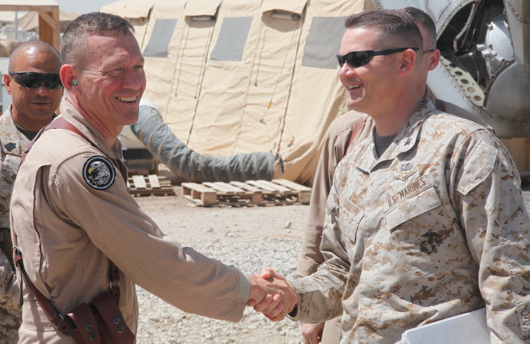 2nd Marine Aircraft Wing Commanding General Maj. Gen. Jon M. Davis greets Col. Russell A.C. Sanborn, the assistant wing commander of 2nd MAW (Forward), on the runway at Camp Bastion, Afghanistan, April 22. Davis visited Marine aviation squadrons deployed to Afghanistan in order to assess the needs of Marines and observe daily operations.