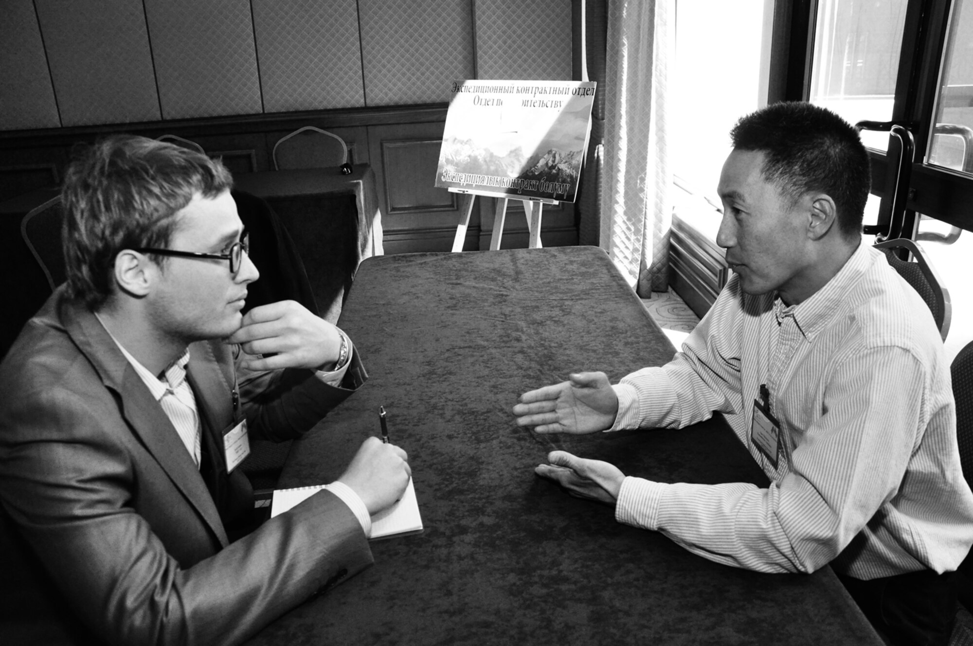 Maj. Alan Villanueva, 376th Air Expeditionary Wing Theater Security Cooperation, explains the Center’s Humanitarian Assistance efforts with a participant attending the Transit Center at Manas’ Industry Day event held at the Hyatt Regency Bishkek April 22. The 376th Expeditionary Contracting Squadron holds Industry Day twice a year to inform prospective businesses on the procedures required to qualify as a vendor with the Center. (U.S. Air Force photo/Master Sgt. Daniel Nathaniel)