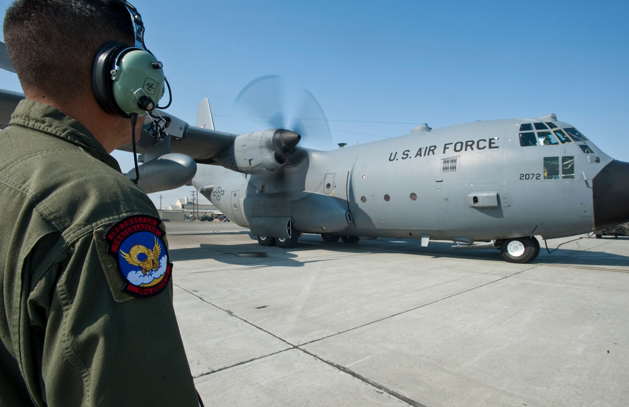 JOINT BASE ELMENDORF-RICHARDSON, Alaska -- Staff Sgt. Adrian Garcia, 39th Airlift Squadron, instructs a crew of C-130 Hercules April 18 as they prepare to take off. The 39th and 40th AS's from Dyess Air Force Base, Texas have three C-130s and approximately 120 Airmen at JBER for Red Flag-Alaska. RF-Alaska is a Pacific Air Forces-directed field training exercise for the U.S. and coalition forces flown under simulated air combat conditions. It is conducted on the Joint Pacific Alaskan Range Complex, the largest air-ground training complex in America. (Air Force photo/Senior Airman Christopher Gross)