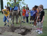 LAUGHLIN AIR FORCE BASE, Texas – A Laughlin youth puts the first scoop of dirt on a freshly planted tree at Laughlin’s Leaning Pines Golf Course April 21 during an Arbor Day ceremony. Jack Johnson, a ranger with the National Park Service, spoke at the ceremony and Col. Angela Cadwell, 47th Mission Support Group commander, signed a proclamation declaring Laughlin’s recognition of Arbor Day. (U.S. Air Force photo by Airman 1st Class Blake Mize)