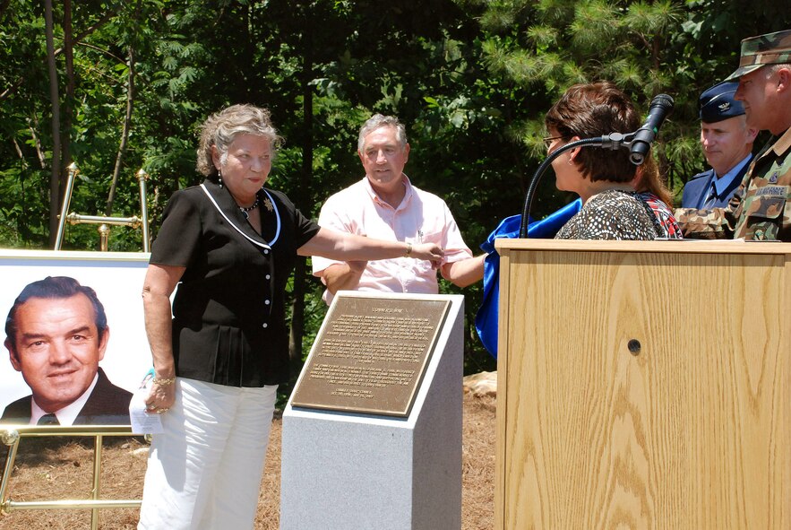 Thera Conner uncovers the memorial plague located along Conner’s Way trail which dedicates the trail in honor of her late husband, Charles “Doug” Conner, Jun 5, 2008.  Doug Conner worked many years in the Dobbins Safety office with a vision to create a safe walking path between lodging and the Base Exchange area but was unsuccessful in seeing his vision through.   Ron Durant, to Mrs. Conner’s left, took over that vision and with persistence, saw it through to completion.  The newest jogging path connects the Conner’s Way trail with the Navy path originating at the south side gymnasium.  Soon anyone with base access can run or stroll safely and uninterrupted, from the Dobbins lodging facility all the way to the former Navy gym located on the southwest side of the runway. 