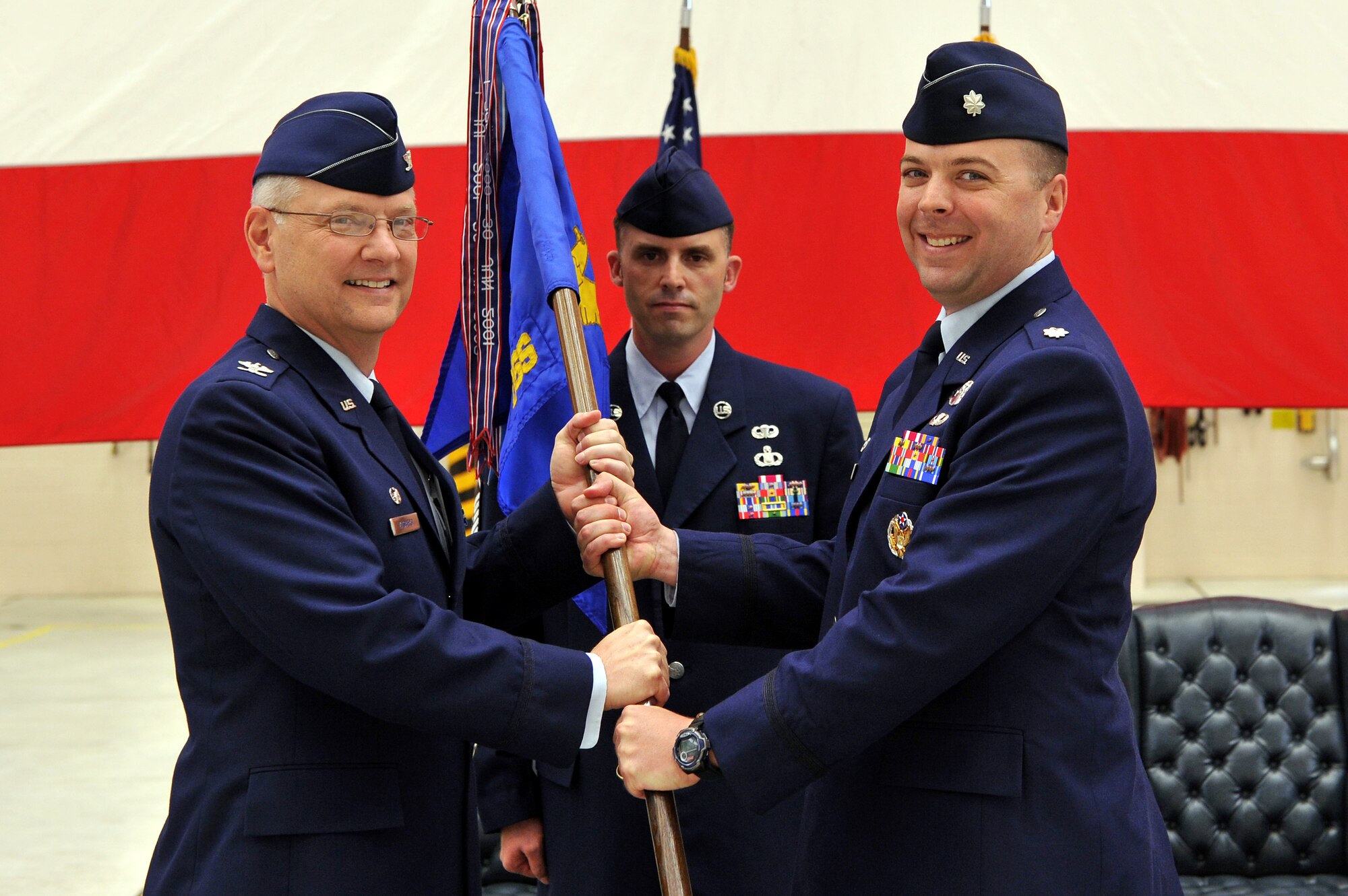 Lt. Col. Kevin Wade (right), incoming 19th Operations Support Squadron commander, accepts the guidon and command of the unit from Col. David Kasberg, 19th Operations Group commander, April 22, 2011, at Little Rock Air Force Base, Ark.  The 19th OSS provides operational support to the wing through scheduling, tactics, aircrew flight equipment, training and aerial delivery, airfield and weather support in a coordinated effort to guarantee successful world-wide airlift operations.  (U.S. Air Force photo by Staff Sgt. Chris Willis)