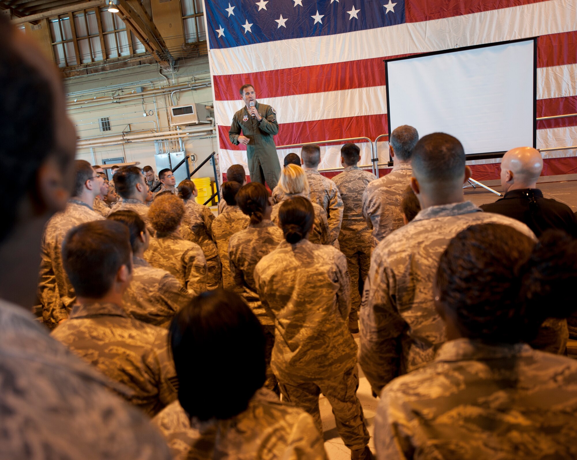 HOLLOMAN AIR FORCE BASE, N.M. -- Col. David Krumm, 49th Wing commander, speaks to Airmen about the improvements Team Holloman has made in the past 10 months for the fast-approaching Operational Readiness Inspection during one of three Commander’s Calls at Hangar 301 April 15, 2011. Colonel Krumm said scores across the wing -- to include operational security, information operations, employment readiness and deployment processing --have increased tenfold since the base preparation efforts. (U.S Air Force photo by Senior Airman Veronica Stamps/Released)