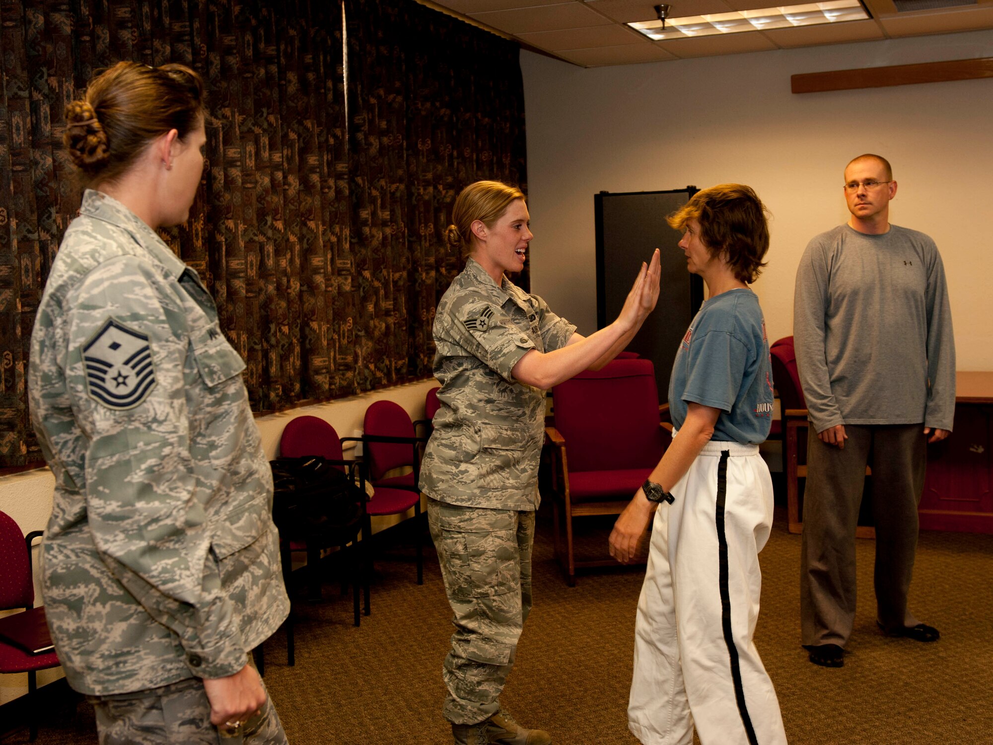 HOLLOMAN AIR FORCE BASE, N.M. – Senior Airman Sondra Escutia, 49th Wing, practices an avoidance technique on Overstreet TaeKwonDo instructor, Anna Scott, during a Training for Life self-defense class at the Community Activity Center April 13, 2011. The class educated participants on multiple low-liability ways to avoid and escape a bad situation and was held in conjunction with Sexual Assault Awareness Month. (Photo by Tracey Spencer/Released) 