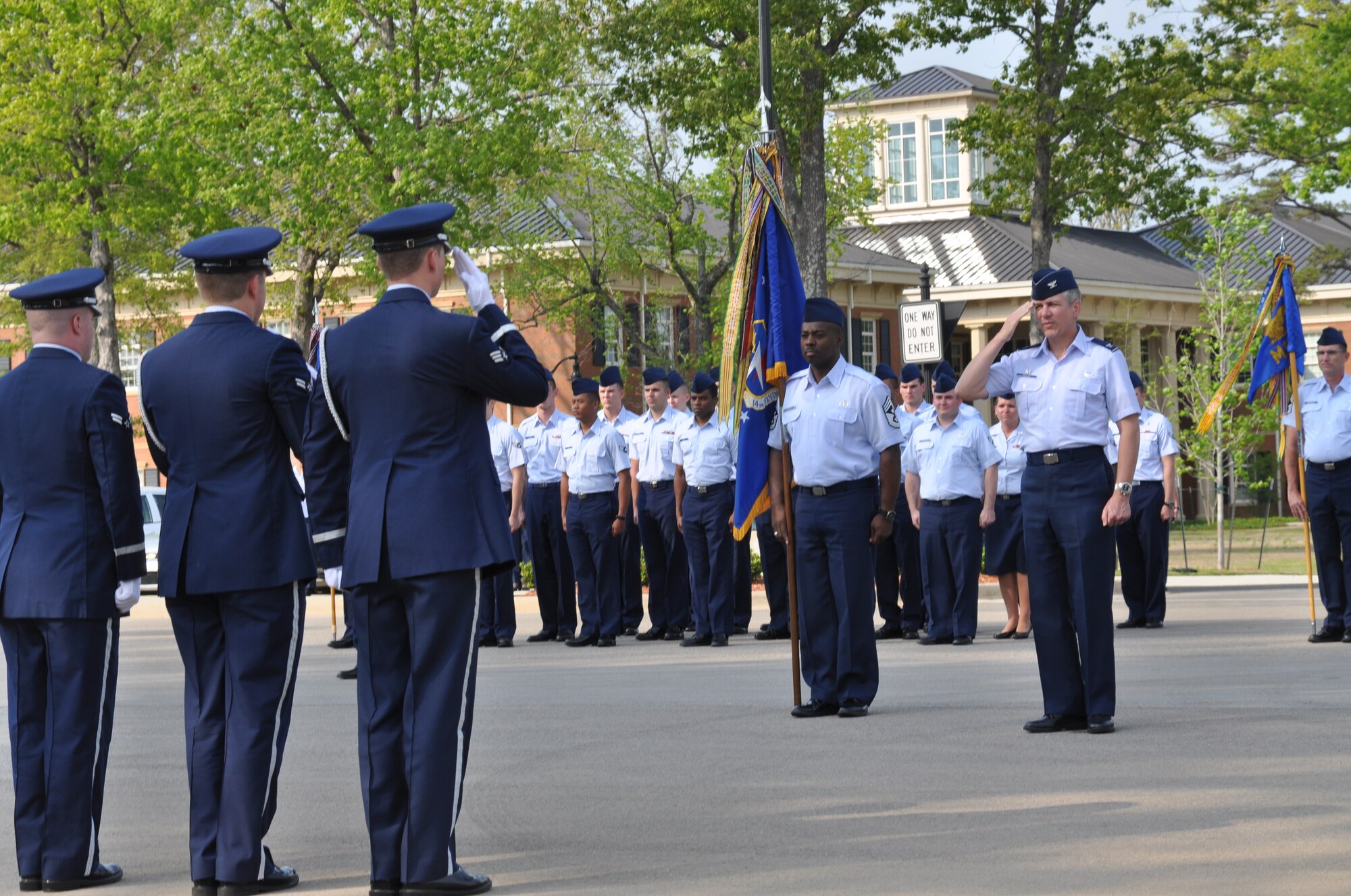 Col. Barre Seguin, 14th Flying Training Wing commander, confirms the flag is secure after the wing retreat ceremony April 18 at Smith Plaza. The retreat ceremony signals the end of the duty day. (U.S. Air Force photo/Airman 1st Class Chase Hedrick)
