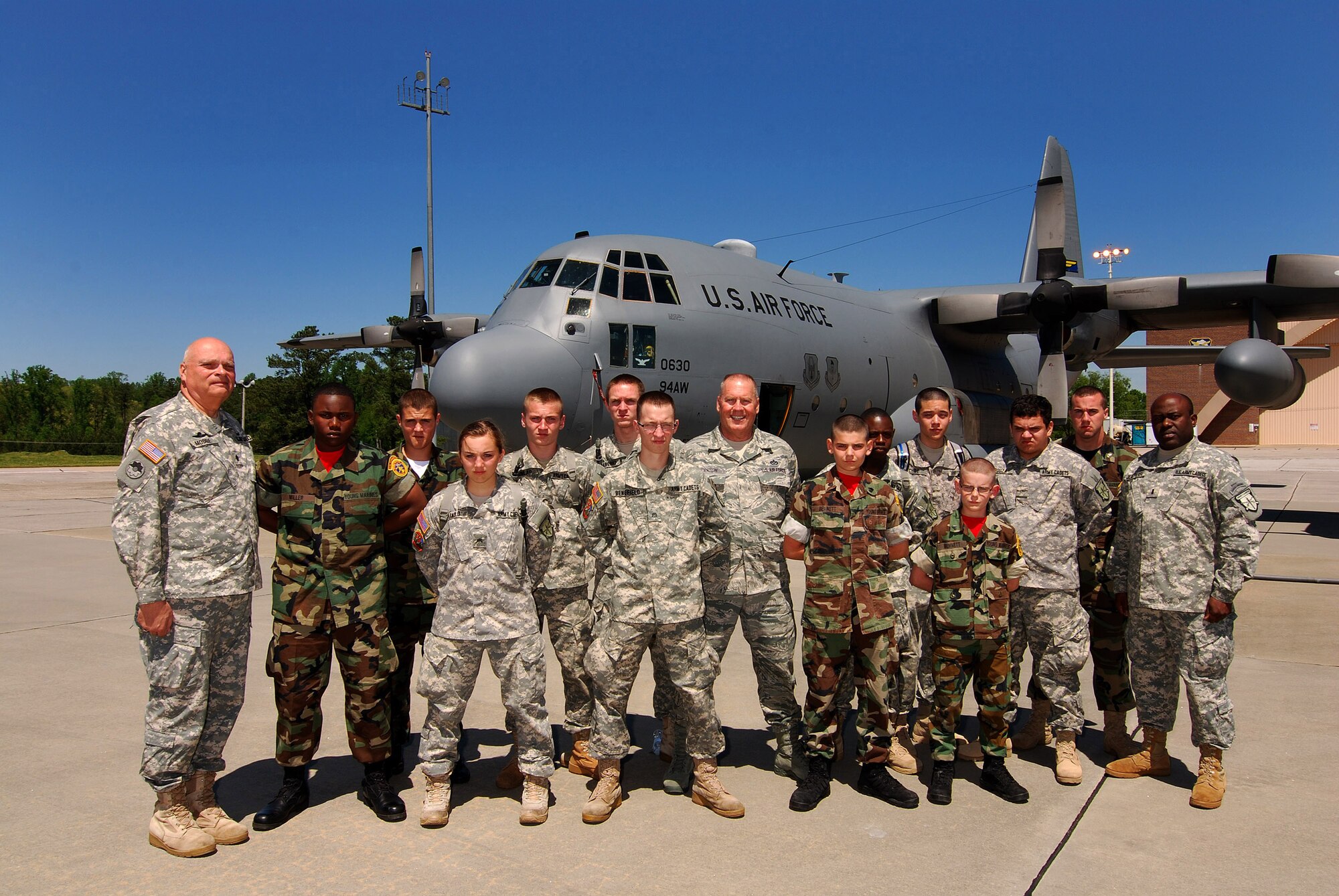 Lt. Col. Larry Moore (left), 94th Airlift Wing Command Chief, Chief Master Sgt. John Anderson (middle), and 1st Lt Marc Jean Pierre (right) stand with a hard working group of volunteers from the Georgia Army Cadets and Metro Atlanta Young Marines.  The young volunteers directed traffic for two days while the 94th Airlift Wing and Dobbins Air Reserve Base hosted more than 1,500 high school JROTC cadets for a look at the Wing and a familiarization flight on a C-130H2 Hercules aircraft.   (U.S. Air Force photo/ Brad Fallin)