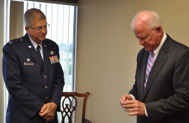 Col. Timothy Tarchick, 94th Airlift Wing Commander, presents Sen. Saxby Chambliss with a unit coin April 20, 2011 in recognition of the support the senator has provided to service members stationed at Dobbins Air Reserve Base, Ga. Colonel Tarchick met with the senator at his regional office in Atlanta to discuss current and future operations involving Airmen assigned to Dobbins Air Reserve Base, Ga.