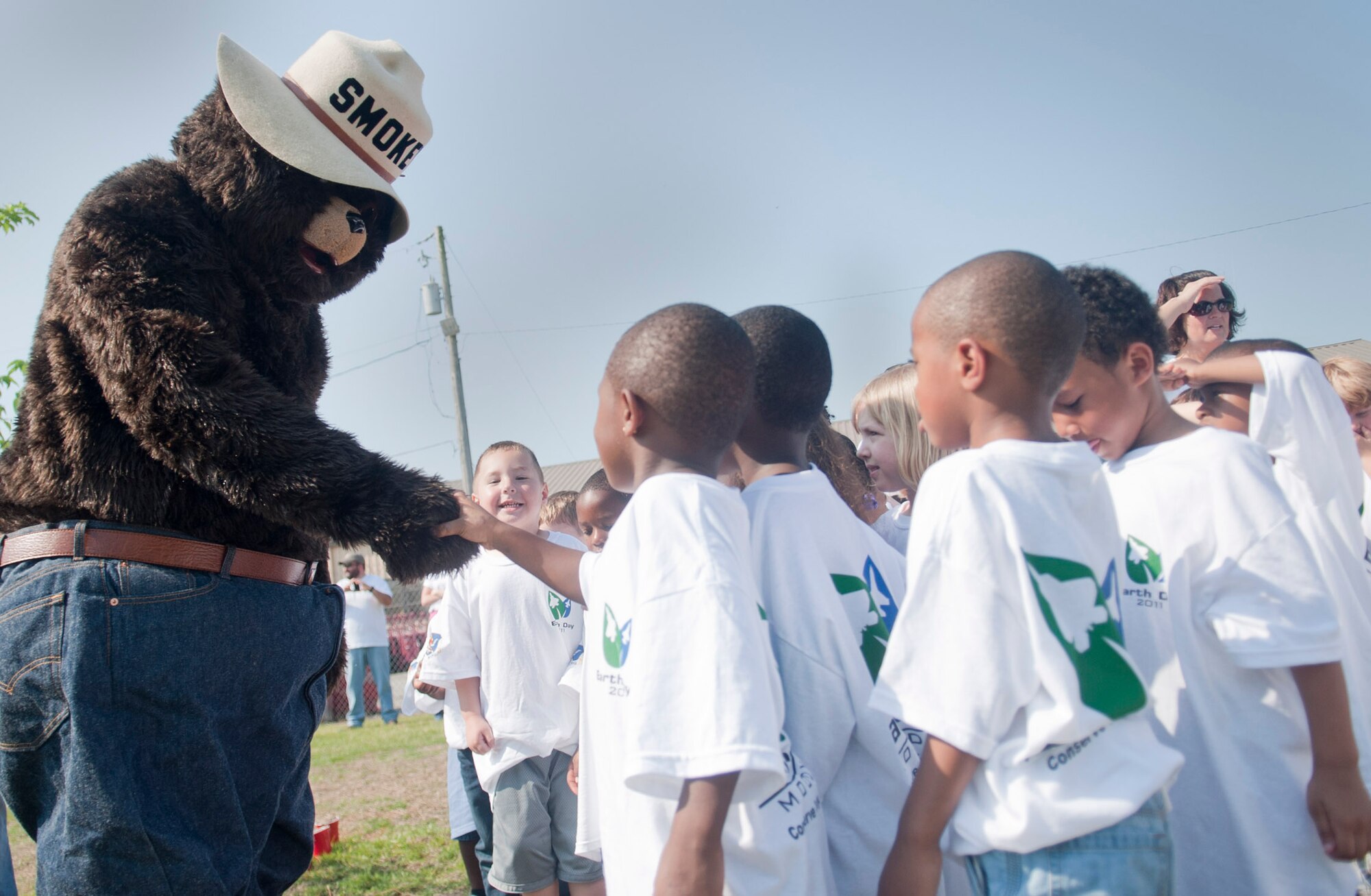 MOODY AIR FORCE BASE, Ga. -- Children from the Child Development Center pre-school class greet Smokey the bear after planting a tree for Earth Day April 22. Smokey the Bear encouraged the children to keep the Earth clean and healthy for a better future. (U.S. Air Force photo/Airman 1st Class Douglas Ellis)(RELEASED)
