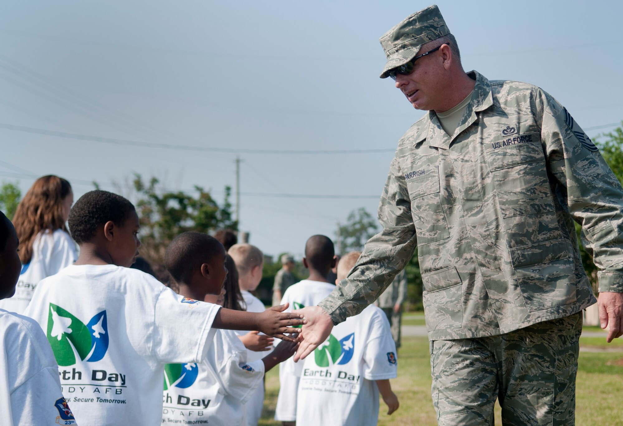 MOODY AIR FORCE BASE, Ga. -- Chief Master Sgt. Jerry Parrish, 23rd Civil Engineer Squadron chief enlisted manager, high fives children from the Child Development Center pre-school class April 22. The children later helped plant a tree in celebration of Earth Day. (U.S. Air Force photo/Airman 1st Class Douglas Ellis)(RELEASED)
