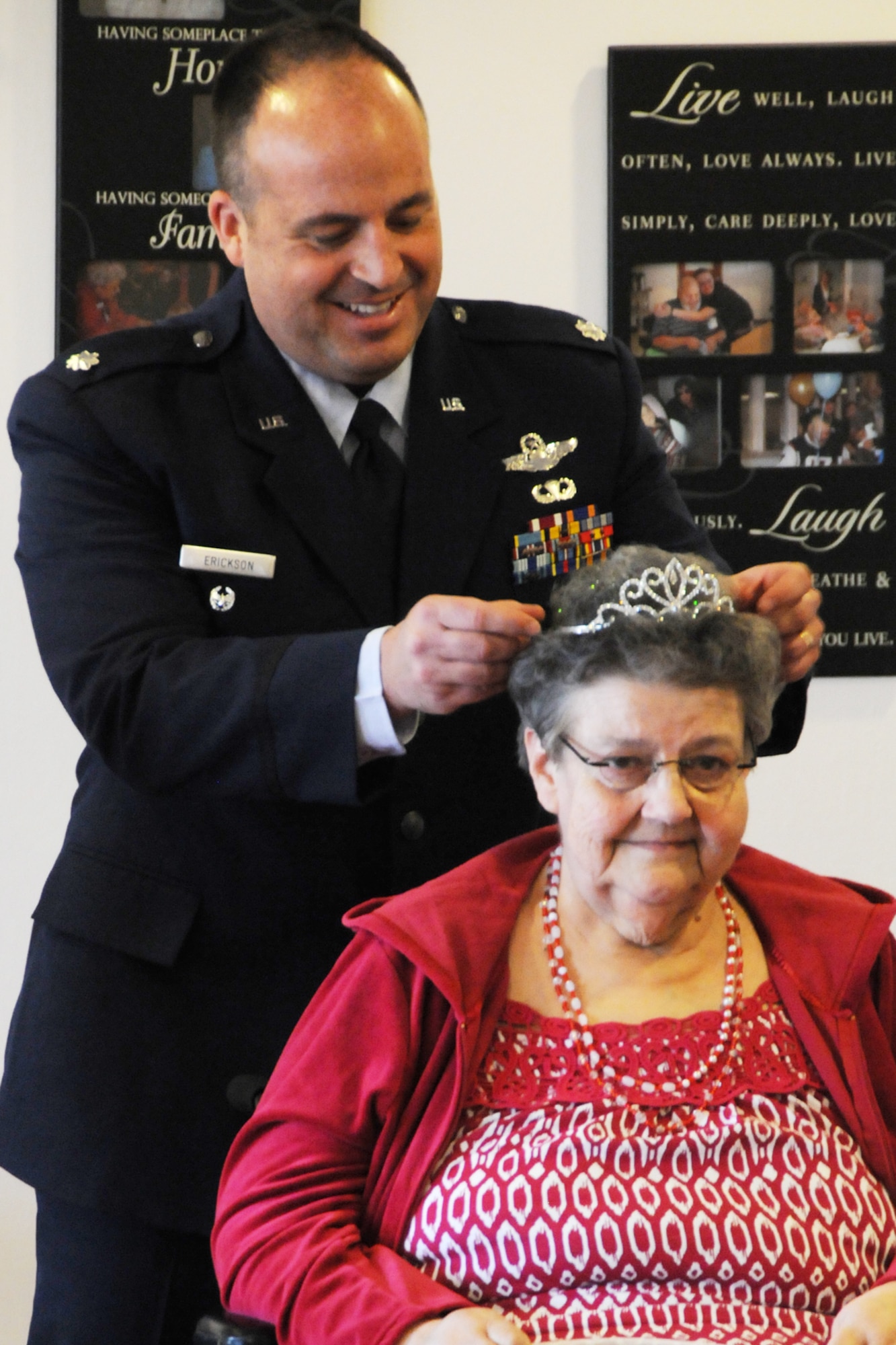 Lt. Col. Robert Erickson, State Director of Air Operations, crowns  Mrs. Joanne Hollenbeak the 2011 Rose Queen.  Members of the Oregon Air National Guard volunteered to help with the 2011 Rose Queen Corenation ceremony at Plum Ridge Marquis Care in Klamath Falls, Ore. April 8, 2011. (U.S. Air Force Photo by Tech.Sgt. Jennifer Shirar, RELEASED)
