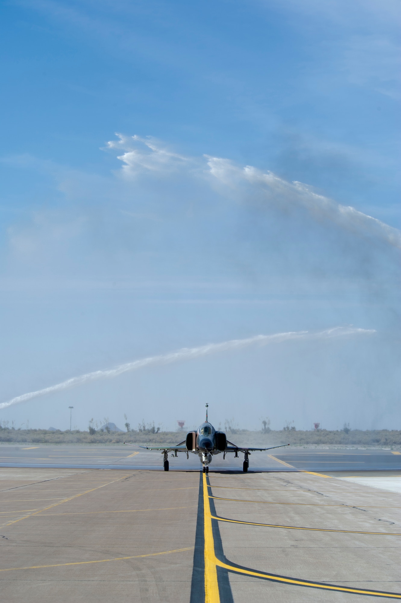HOLLOMAN AIR FORCE BASE, N.M. -- Col. Robert McCutchen, 56th Fighter Wing at Luke AFB Ariz., taxis beneath a celebratory water arch, April 20, 2011, after completing his final flight.  Colonel McCutchen, a command pilot with more than 5,000 hours in the F-16 Fighting Falcon, chose the historic F-4 Phantom for his final flight before retirement. Holloman is one of only a few bases that actively fly this aircraft. Entering service in 1960, the aircraft changed the landscape of airpower worldwide and served with distinction in Vietnam, Korea and Desert Storm and was retired from active service in 1996. (U.S. Air Force photo by Tech. Sgt. Joe Laws/Released)