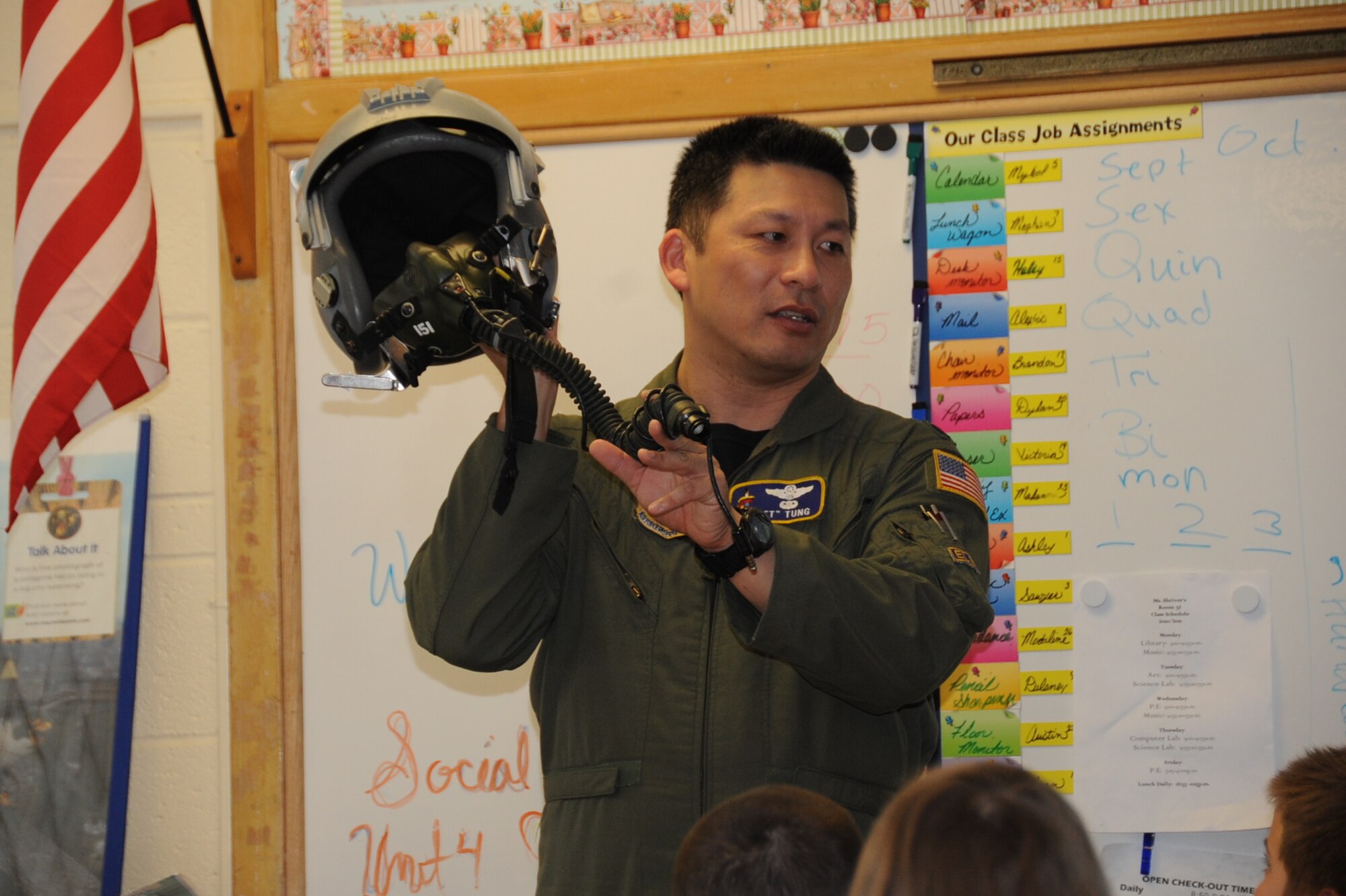 Lieutenant Col. Tsuyoshi "T" Tung, 18th Air Refueling Squadron shows a flight helmet to students at McLean Science/Technology Magnet School in Wichita, April 21. Colonel Tung spoke to more than 120 primary school students about the Air Force and the skills required to fly aircraft during the McLean Air & Flight Extravaganza. (Air Force photo by Brannen Parrish)
