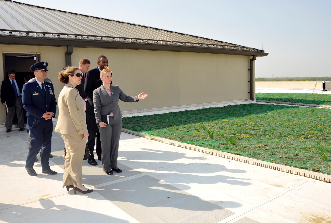 Susan Bench-Snow, Secretary of the Air Force Administrative Assistant Facilities director, shows Under Secretary of the Air Force Erin Conaton the ?green? roof of the William A. Jones III Building following an Earth Day and Arbor Day tree planting ceremony at Joint Base Andrews, Md., April 20, 2011. The roof of the Jones Building is lined with low maintenance flora, which will not exceed more than eight inches in height and keeps the building cooler in the warmer months while using less energy. (U.S. Air Force photo/ Senior Airman Melissa V. Brownstein)