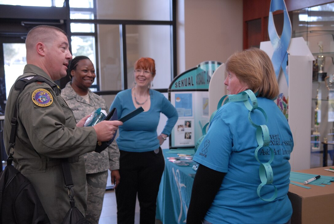 VANDENBERG AIR FORCE BASE, Calif. -- Members from the 30th Space Wing sexual assault prevention and response team educate Team V members at the base fitness center Thursday, April 14, 2011.  The team consists of personnel from the 30th Space Wing SARC office, victim advocates and Team V volunteers.  (U.S. Air Force photo/Staff Sgt. Andrew Satran) 

 
 