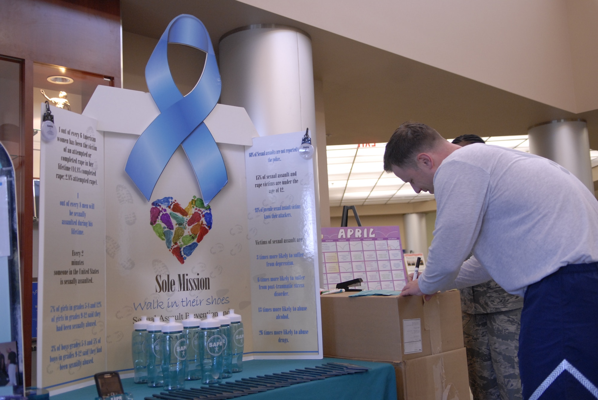 VANDENBERG AIR FORCE BASE, Calif. -- Writing an inspirational phrase, Capt. Jake Malone, a 1st Air and Space Test Squadron member, donates his link to spread the message for Sexual Assault Awareness month at the base fitness center Thursday, April 14, 2011.  The goal of the 30th Space Wing sexual assault response coordinator office for Sexual Assault Awareness month is sending the message of sexual assault prevention to all age groups and ranks on base.  (U.S. Air Force photo/Staff Sgt. Andrew Satran) 

 