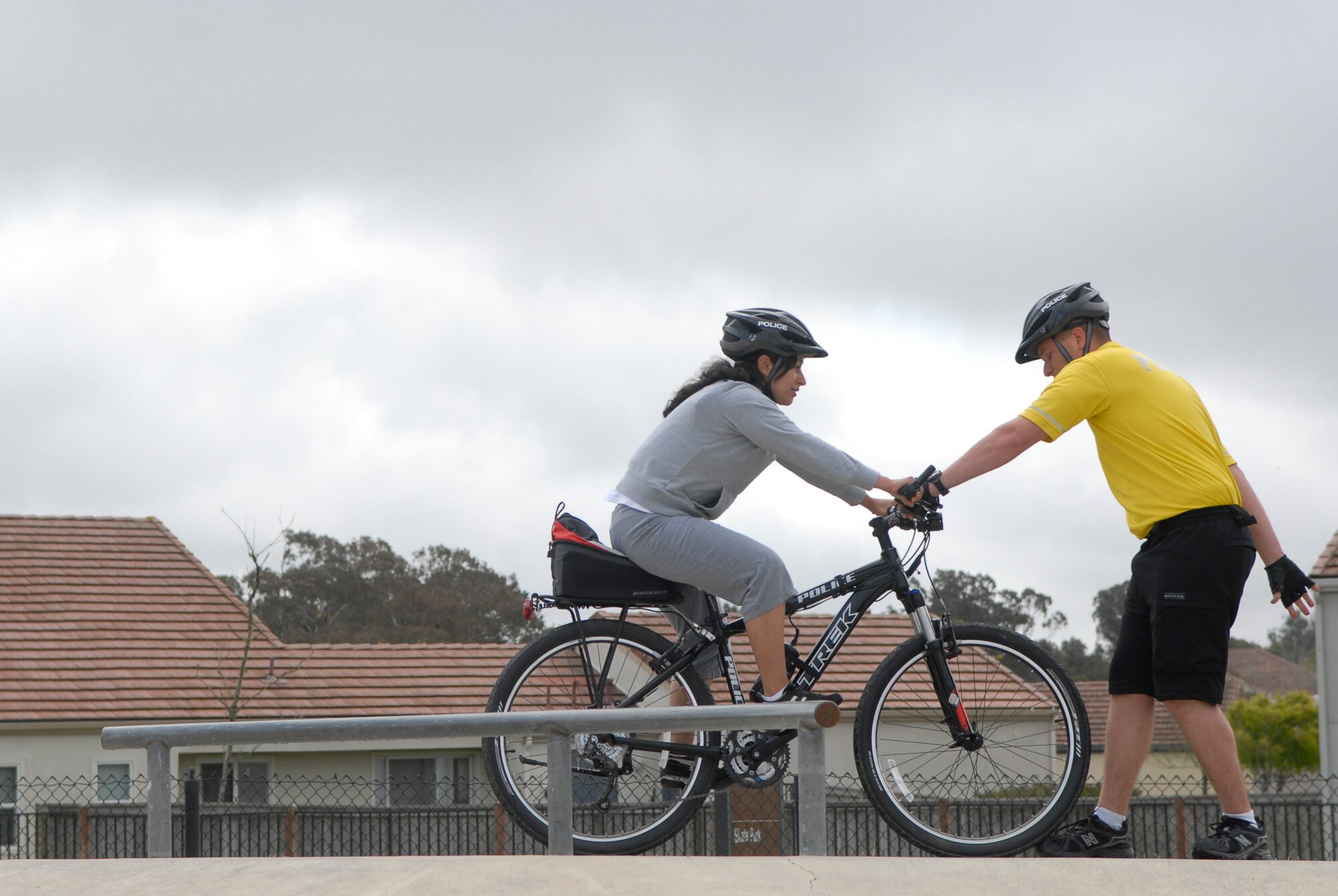 VANDENBERG AIR FORCE BASE, Calif. -- Showing the proper technique, Staff Sgt. Brandon Johnson, gives Airman 1st Class Alejandra Solis-Morales, a 30th Security Forces Squadron response force member, instructions on positioning during the bike patrol training here Tuesday, April 19, 2011.  The 30th SFS Bike Patrol is being reinstated to show a proactive police force for community members on base.  (U.S. Air Force photo/Staff Sgt. Andrew Satran) 

 
   