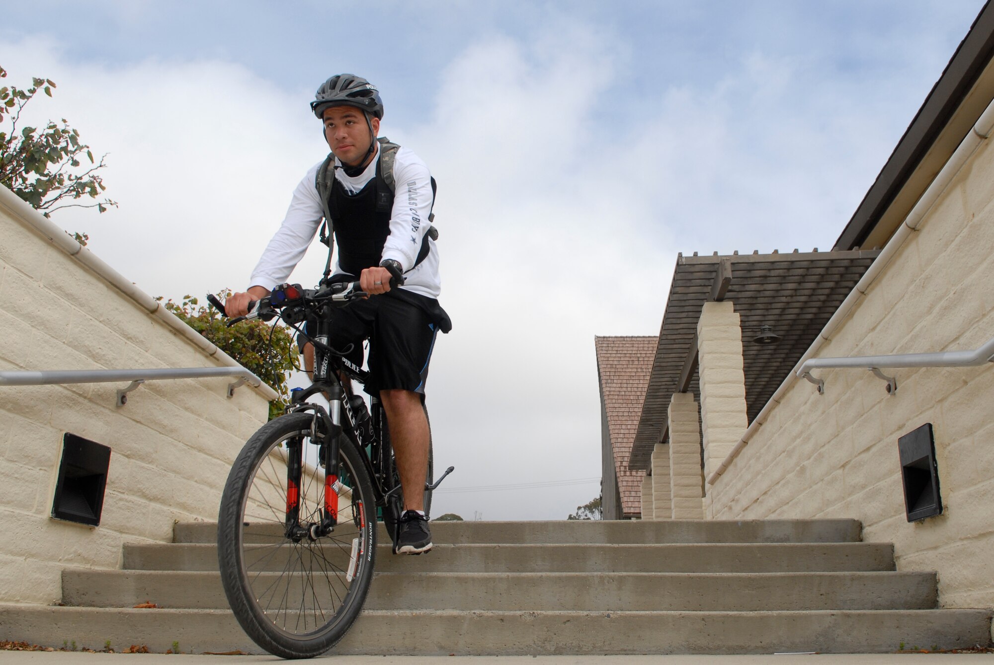 VANDENBERG AIR FORCE BASE, Calif. -- Carefully riding down the stairs, Airman 1st Class David Trevino, a 30th Security Forces Squadron response force member, practices riding on different terrain  during the bike patrol training here Tuesday, April 19, 2011.  The trainees practiced figure eight turns, dodging objects and detaining on the bicycle. (U.S. Air Force photo/Staff Sgt. Andrew Satran) 

   