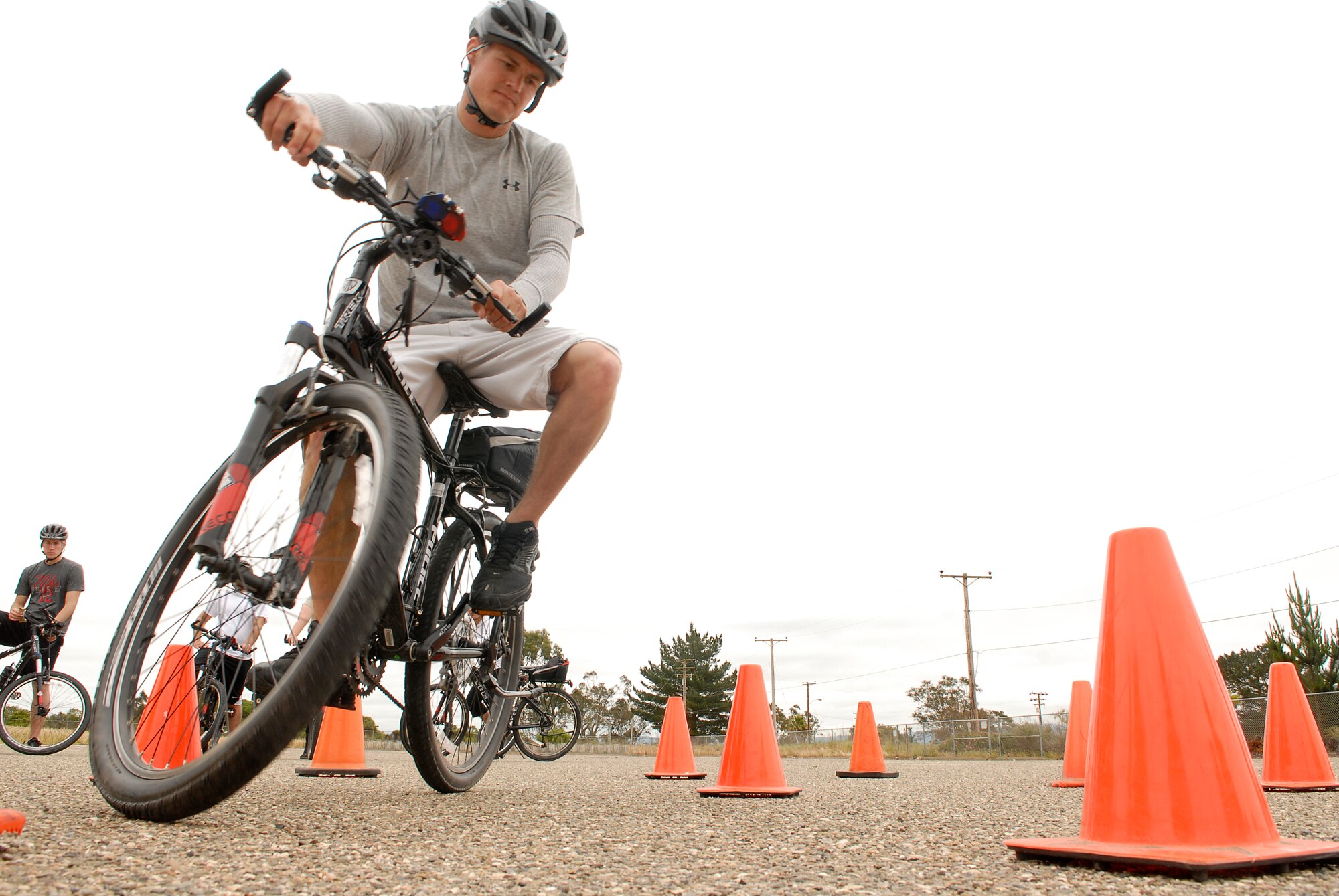 VANDENBERG AIR FORCE BASE, Calif. -- Making a sharp turn, Senior Airman Steven Koster, a 30th Security Forces Squadron response force member, performs a figure eight during the bike patrol training here Tuesday, April 19, 2011. 30th SFS Bike Patrol trainees practiced figure eight turns, dodging objects and detaining on the bicycle.  (U.S. Air Force photo/Staff Sgt. Andrew Satran) 

 
 
  
