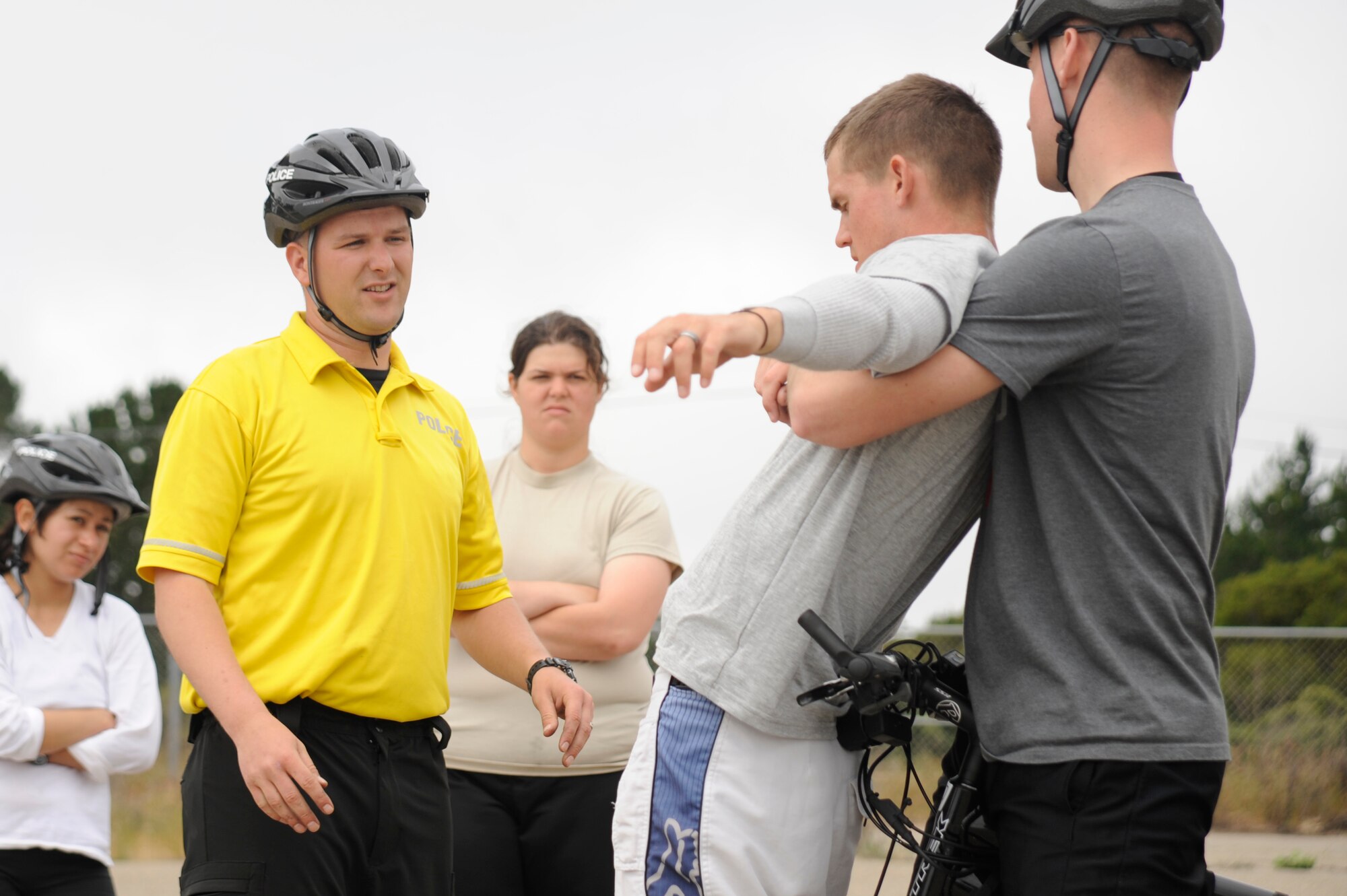 VANDENBERG AIR FORCE BASE, Calif. -- Training the new members of the bike patrol, Staff Sgt. Brandon Johnson, a 30th Security Forces Squadron Bike Patrol instructor, shows a proper way to detain a subject during the bike patrol training class here Tuesday, April 19, 2011.  During the class trainees learned maintenance on the bicycles, rules of the road and patrol techniques.  (U.S. Air Force photo/Staff Sgt. Andrew Satran) 

  