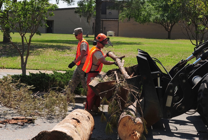Airman 1st Class Bryan Whitford, 23rd Civil Engineer Squadron heavy equipment operator, loads tree branches onto a loader truck  during a Hurricane Evacuation Exercise April 21 at Moody Air Force Base, Ga. Hurricane Kristy’s movement through Moody damaged a few trees and left debris on the roads (U.S. Air Force photo/Senior Airman Stephanie Mancha)(RELEASED)