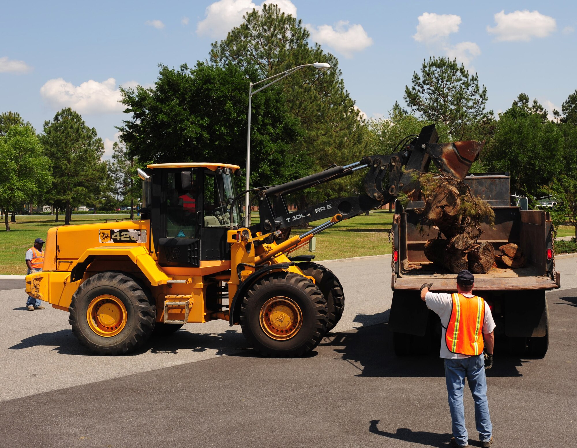 Staff Sgt. Renner Petty, 23rd Civil Engineer Squadron heavy equipment operator, dumps a tree stump onto a truck during a Hurricane Evacuation Exercise April 21 at Moody Air Force Base, Ga. The loader truck made it easy for the heavy equipment operators to remove all debris from the roads to make it safe for Airmen to drive. (U.S. Air Force photo/Senior Airman Stephanie Mancha)(RELEASED)