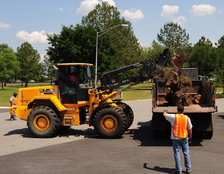 Staff Sgt. Renner Petty, 23rd Civil Engineer Squadron heavy equipment operator, dumps a tree stump onto a truck during a Hurricane Evacuation Exercise April 21 at Moody Air Force Base, Ga. The loader truck made it easy for the heavy equipment operators to remove all debris from the roads to make it safe for Airmen to drive. (U.S. Air Force photo/Senior Airman Stephanie Mancha)(RELEASED)