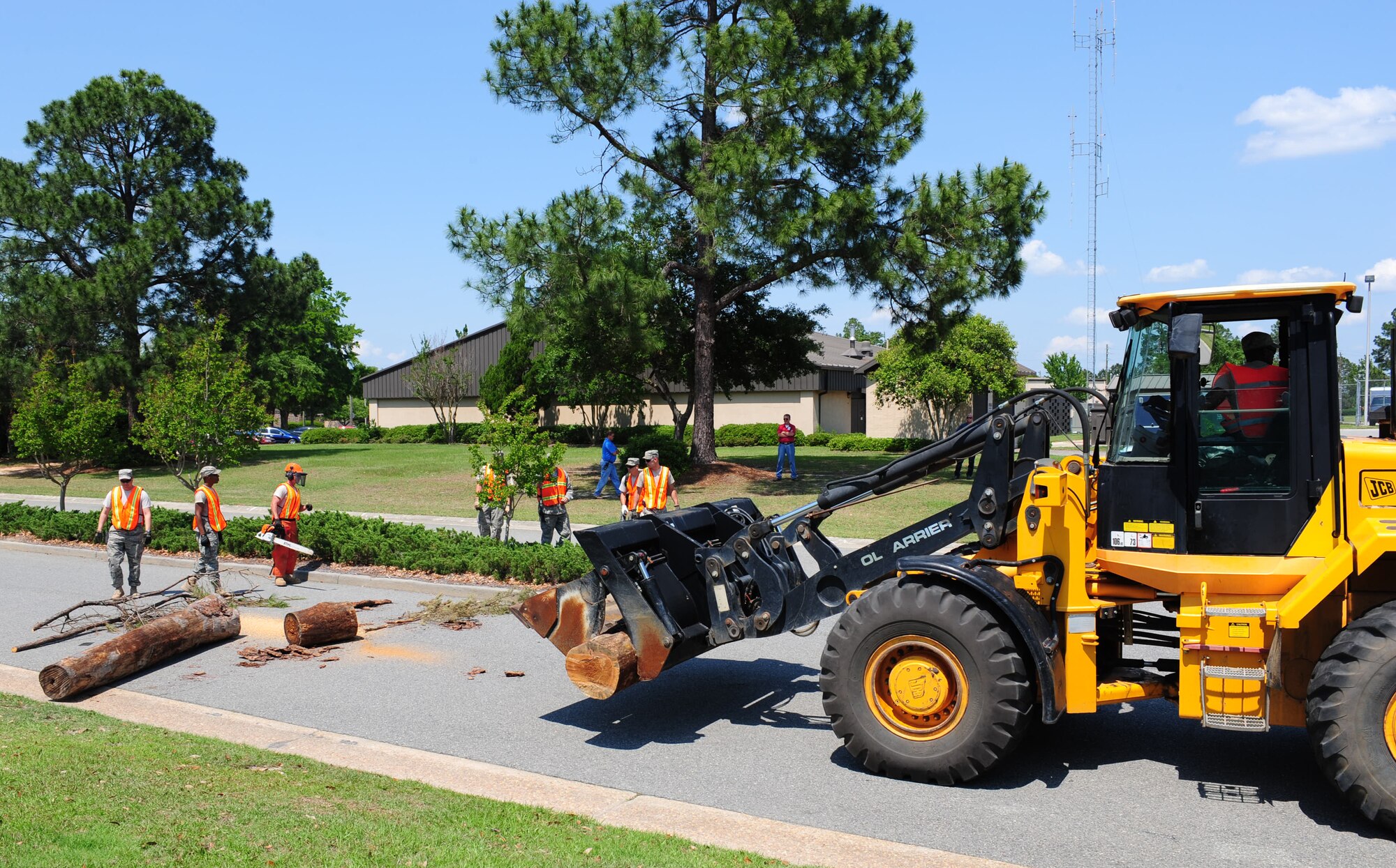 Members from the 23rd Civil Engineer Squadron heavy equipment operators clear the roads using a chain saw, backpack blowers and a loader truck after being hit by Hurricane Kristy during a Hurricane Evacuation Exercise April 21 at Moody Air Force Base, Ga. This portion of the exercise tested the knowledge, equipment and capabilities of the 23rd CES heavy equipment operators in the event a natural disaster hits the base. (U.S. Air Force photo/Senior Airman Stephanie Mancha)(RELEASED)