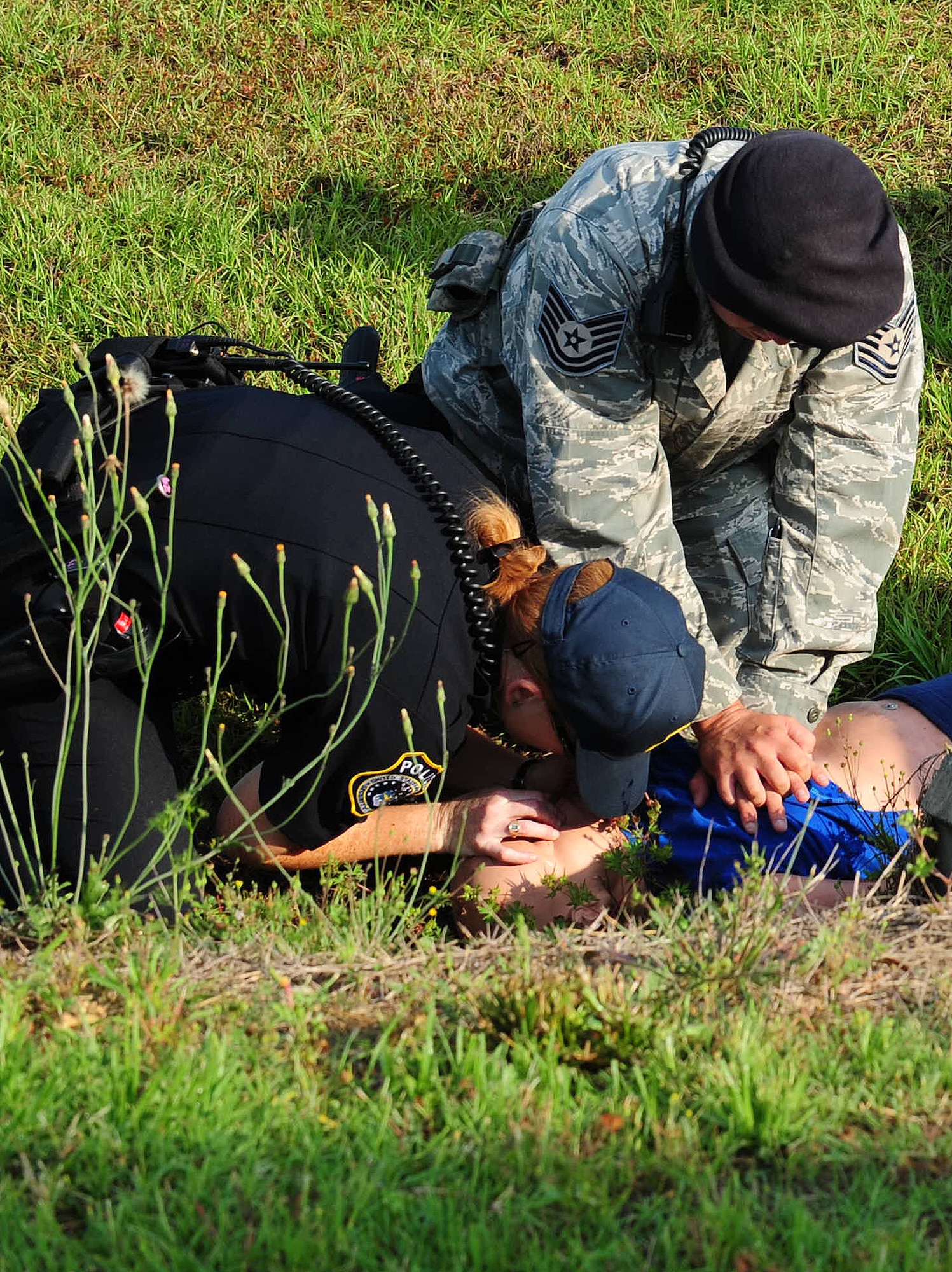Rachelle Denmark, Department of the Air Force security guard, provides breaths exhaling into the mouth of the victim during a Hurricane Evacuation Exercise April 21 at Moody Air Force Base, Ga. The universal compression to ventilation ratio is 30:2; in an effort to create artificial circulation by manually pumping blood through the heart and pushing air into the lungs. (U.S. Air Force photo/ Senior Airman Stephanie Mancha)(RELEASED)