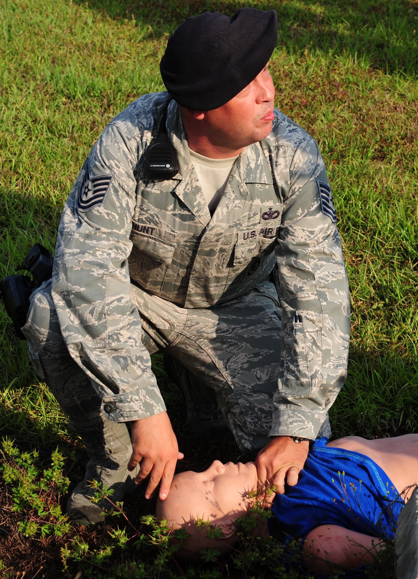 Tech. Sgt.  Mark Hunt, 23rd Security Forces Squadron flight chief, checks the victims breathing and pulse during Hurricane Evacuation Exercise April 21 at Moody Air Force Base, Ga. The victim was unresponsive, not breathing and had no pulse. (U.S. Air Force photo/Senior Airman Stephanie Mancha)(RELEASED)