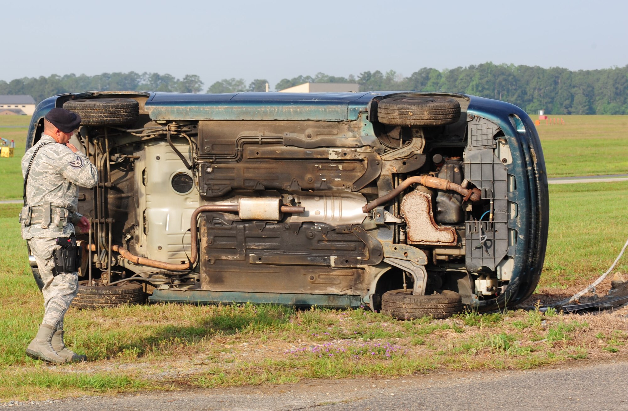 Tech. Sgt. Mark Hunt, 23rd Security Forces Squadron flight chief, responds to a vehicle accident during a Hurricane Evacuation Exercise April 21 at Moody Air Force Base, Ga. The vehicle was thrown into the fence line by a tornado damaging the contractor’s gate. (U.S. Air Force photo/Senior Airman Stephanie Mancha)(RELEASED)
