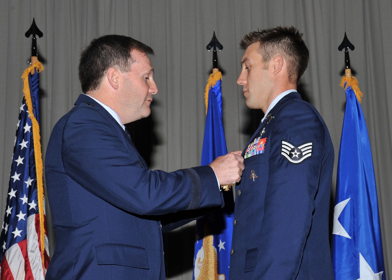 Lt. Gen. Douglas H. Owens, Air Education and Training Command vice commander, presents Staff Sgt. John W. Hatzidakis with the Distinguished Flying Cross with valor during an awards presentation at Forbes Hall April 18. Sergeant Hatzidakis, a pararescue Airman with the 342nd Training Squadron, received the award for his heroic actions during a casualty evaluation of a critically wounded British soldier near Lashkar Gah, Afghanistan. (U.S. Air Force photo/Alan Boedeker)