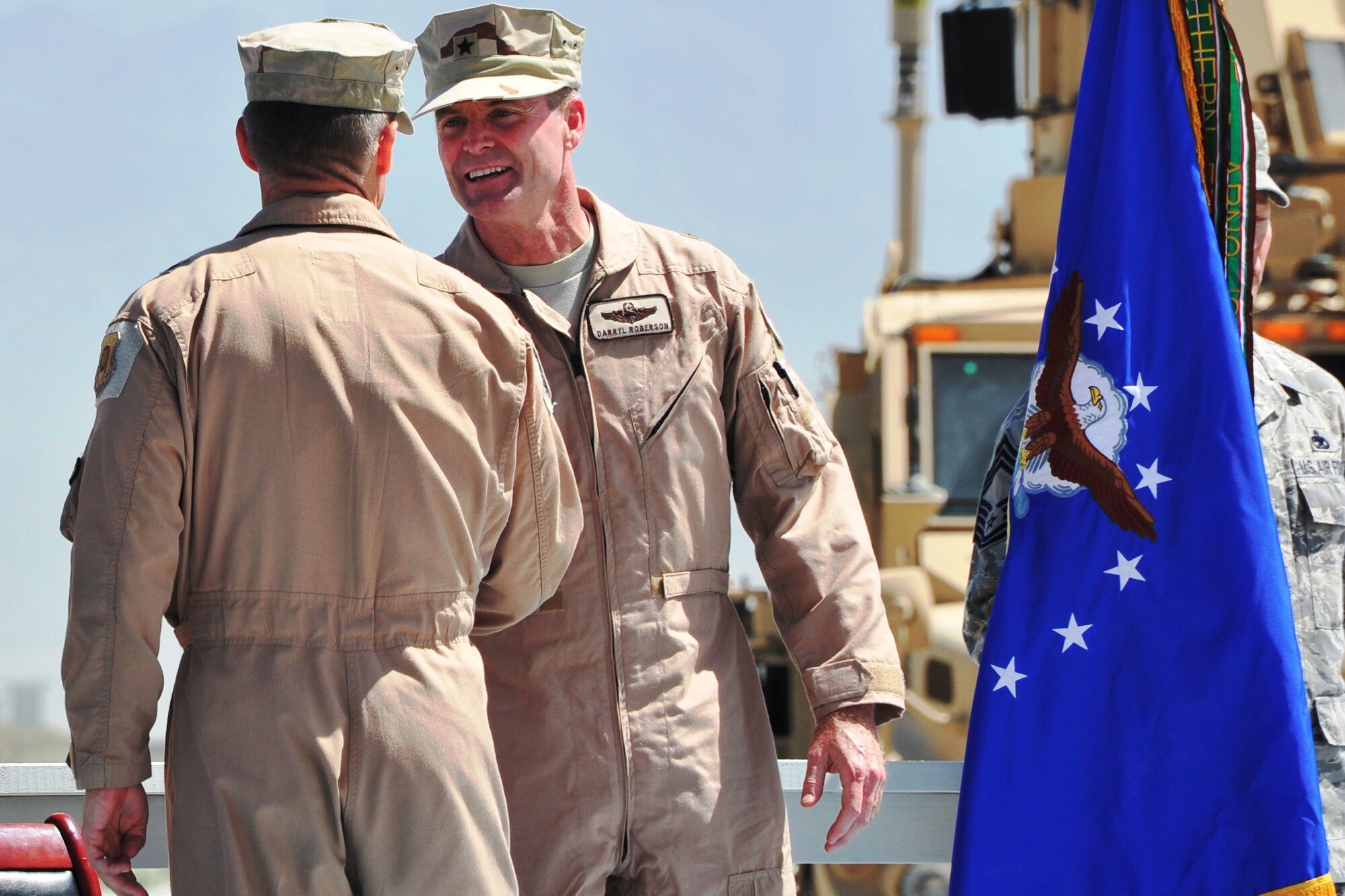 Brig. Gen. Jack L. Briggs II (left), former 455th Air Expeditionary Wing commander, congratulates Brig. Gen. Darryl Roberson, new 455th Air Expeditionary Wing commander, during the wing change of command ceremony at Bagram Airfield, Afghanistan, April 22, 2011.  (U.S. Air Force photo by Capt. Erick Saks)
