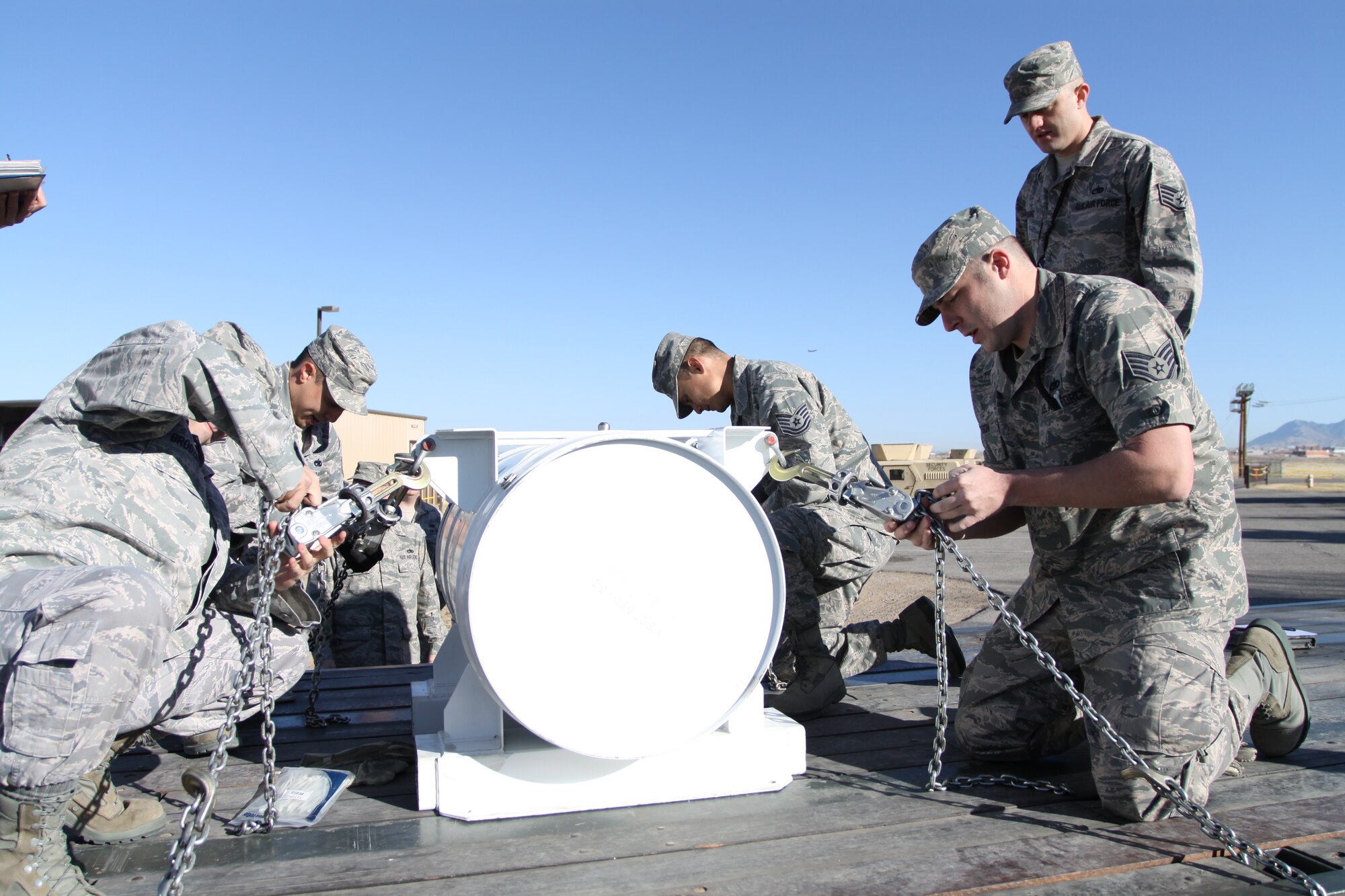 The winning team of Staff Sgt. John Brodzinski, Staff Sgt. Jose Trevino, Tech Sgt. Daryll Mowrey and Staff Sgt. Adam Wilson, completed the fast time “tie-down rodeo” event of an H1388 container to a 40-foot 
flatbed trailer.  Courtesy photo
