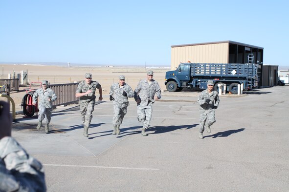 Members of the eventual winning team, from left, Staff Sgt. John Brodzinski, Staff Sgt. Adam Wilson, Staff. Sgt. Jose Trevino, Staff Sgt. Darl Lanning and Tech Sgt. Daryll Mowrey, race toward the 40-foot flatbed trailer at the start of the “tie-down rodeo” event.  Courtesy photo