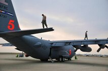 LAUGHLIN AIR FORCE BASE, Texas -- Maintenance personnel from the 302nd Airlift Wing at Peterson Air Force Base, Colo., conduct routine inspections on two C-130s here April 18. The Airmen are currently here in support of the ongoing efforts to contain wildfires in Mexico and Texas. (U.S. Air Force photo by Senior Airman Scott Saldukas)