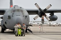 LAUGHLIN AIR FORCE BASE, Texas -- Maintenance personnel from the 302nd Airlift Wing at Peterson Air Force Base, Colo., conduct routine inspections on two C-130s here April 18. The Airmen are currently here in support of the ongoing efforts to contain wildfires in Mexico and Texas. (U.S. Air Force photo by Senior Airman Scott Saldukas)