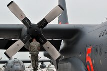 LAUGHLIN AIR FORCE BASE, Texas -- Maintenance personnel from the 302nd Airlift Wing at Peterson Air Force Base, Colo., conduct routine inspections on two C-130s here April 18. The Airmen are currently here in support of the ongoing efforts to contain wildfires in Mexico and Texas. (U.S. Air Force photo by Senior Airman Scott Saldukas)