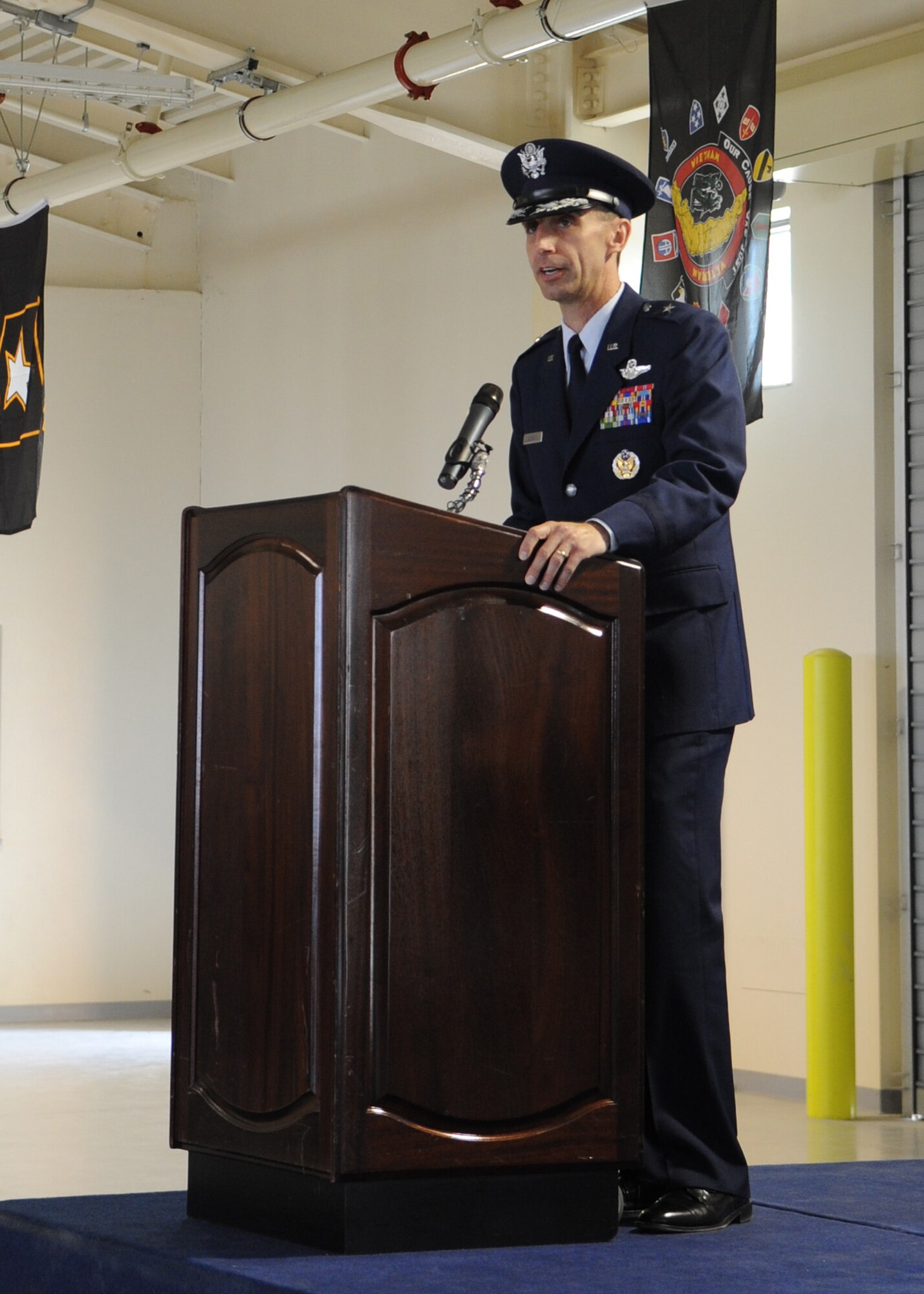 Brig. Gen. Scott Zobrist addresses the 31st Fighter Wing for the first time as the commander during the change of command ceremony April 22 at Aviano Air Base, Italy. General Zobrist was the 388th Fighter Wing commander at Hill Air Force Base, Utah. (U.S. Air Force photo/ Staff Sgt. Nadine Y. Barclay)