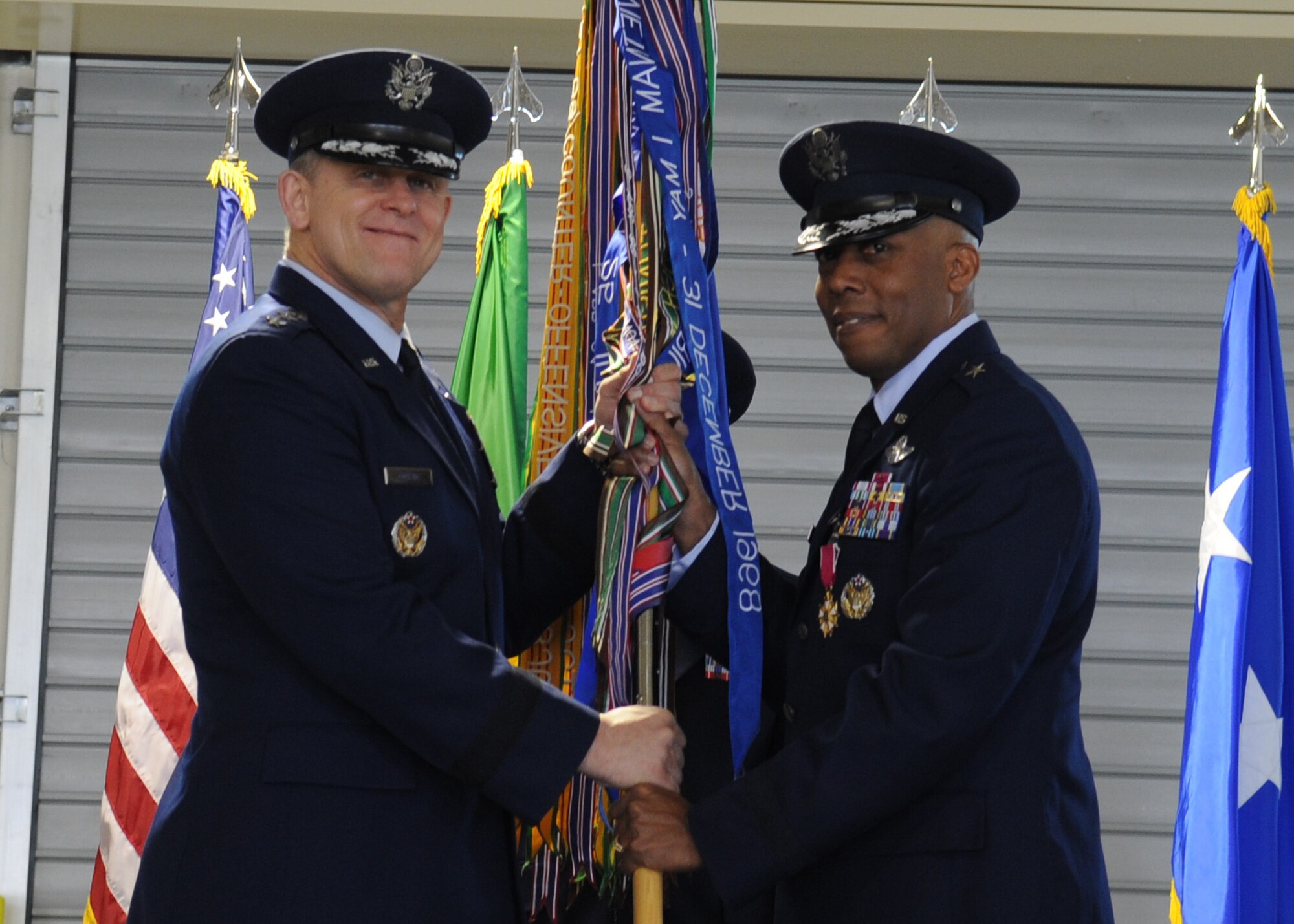 Brig. Gen. Charles Q. Brown Jr., former 31st Fighter Wing commander, passes the 31st FW guidon to Lt. Gen. Frank Gorenc, 3rd Air Force commander, after relinquishing command of the wing during the change of command ceremony April 22 at Aviano Air Base, Italy. General Brown was selected for reassignment as Deputy Director, Operations (J3), Headquarters U.S. Central Command, MacDill Air Force Base, Fla. He relinquished command to Brig. Gen. Scott J. Zobrist. (U.S. Air Force photo/ Staff Sgt. Nadine Y. Barclay)
