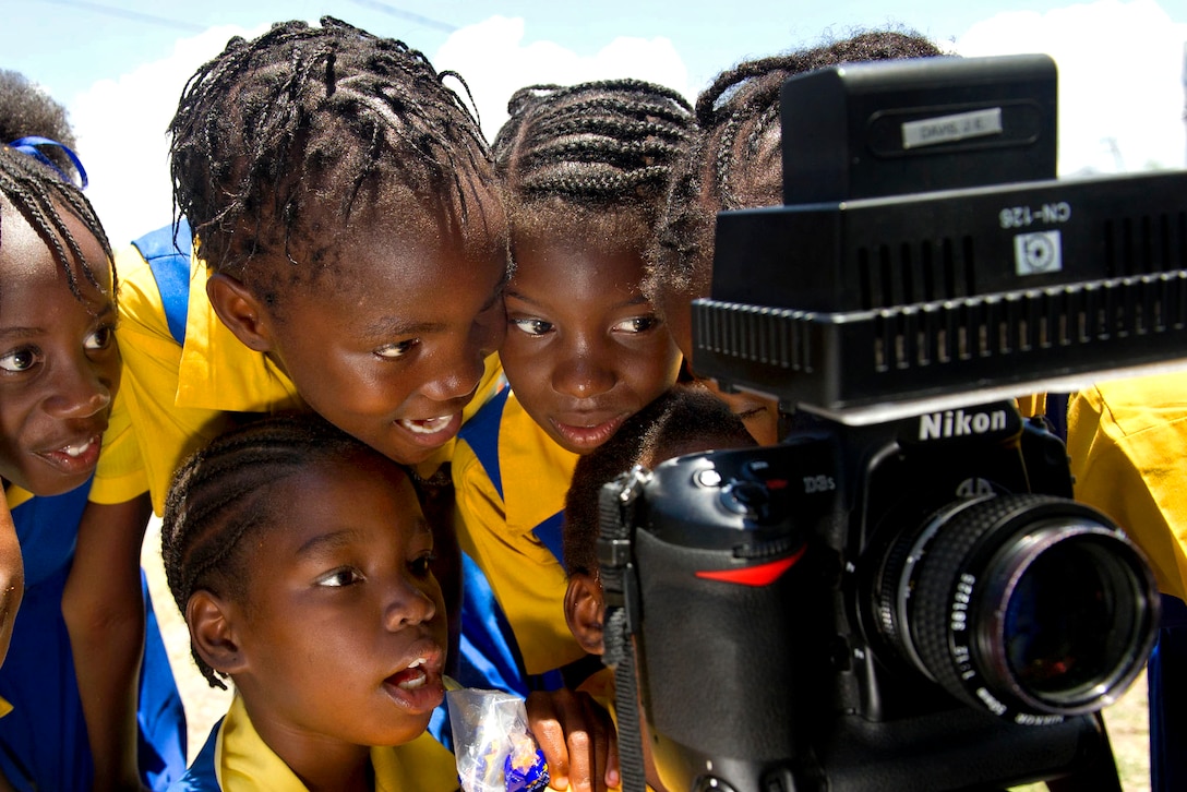 Jamaican school children watch a video recording of themselves singing during a Continuing Promise community service project at Trenchtown Primary School in Kingston, Jamaica, April 19, 2011.