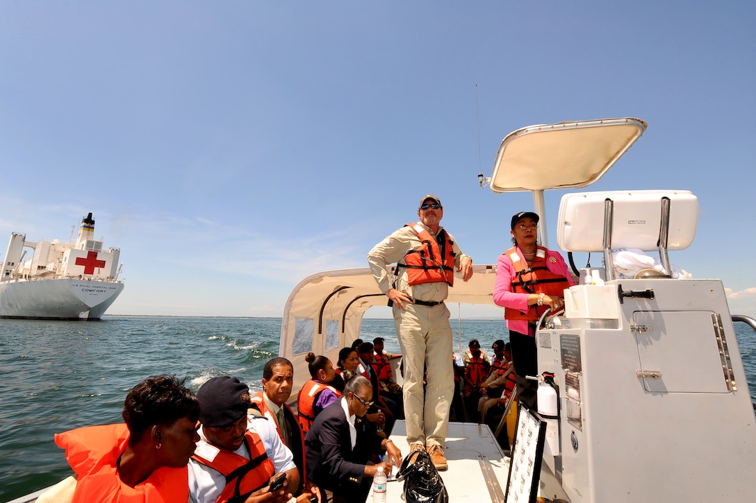 Dr. Marion Bullock Ducasse, senior medical officer, health, special projects director, emergency disaster management, and special services for the Jamaican Ministry of Health, drives a utility boat from the Military Sealift Command hospital ship USNS Comfort to the shore of Kingston, Jamaica, April 19, 2011, after a tour of the ship.
