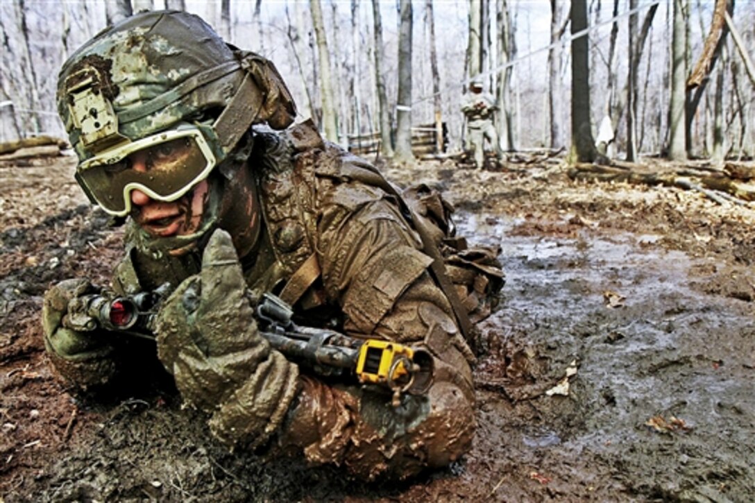 Crawling through mud, U.S. Army Pvt. Charles Shidler searches for the next covered fighting position during training for individual movement techniques at the Camp Ravenna Joint Maneuver Training Center in Ravenna, Ohio, April 17, 2011. The technique is one of more than 200 common tasks that Shidler and about 3,600 other soldiers assigned to the 37th brigade must complete before they deploy to Afghanistan this fall to support Operation Enduring Freedom.