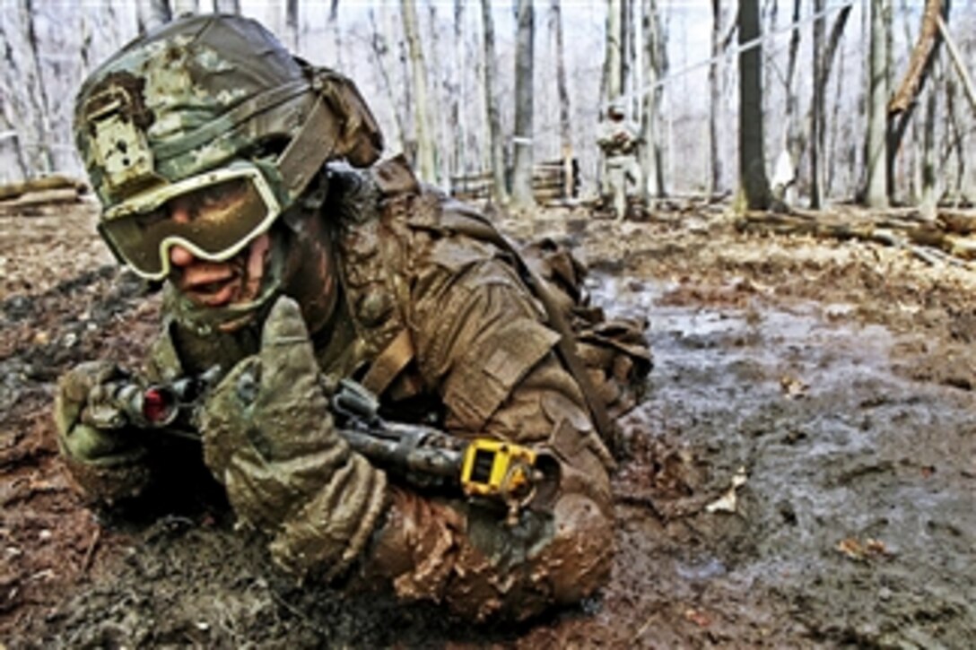 U.S. Army Pvt. Charles Shidler crawls through mud searching for the next covered fighting position during training for individual movement techniques at the Camp Ravenna Joint Maneuver Training Center in Ravenna, Ohio, on April 17, 2011.   The technique is one of more than 200 common tasks that Shidler and about 3,600 other soldiers assigned to the 37th brigade must complete before they deploy to Afghanistan this fall to support Operation Enduring Freedom.  