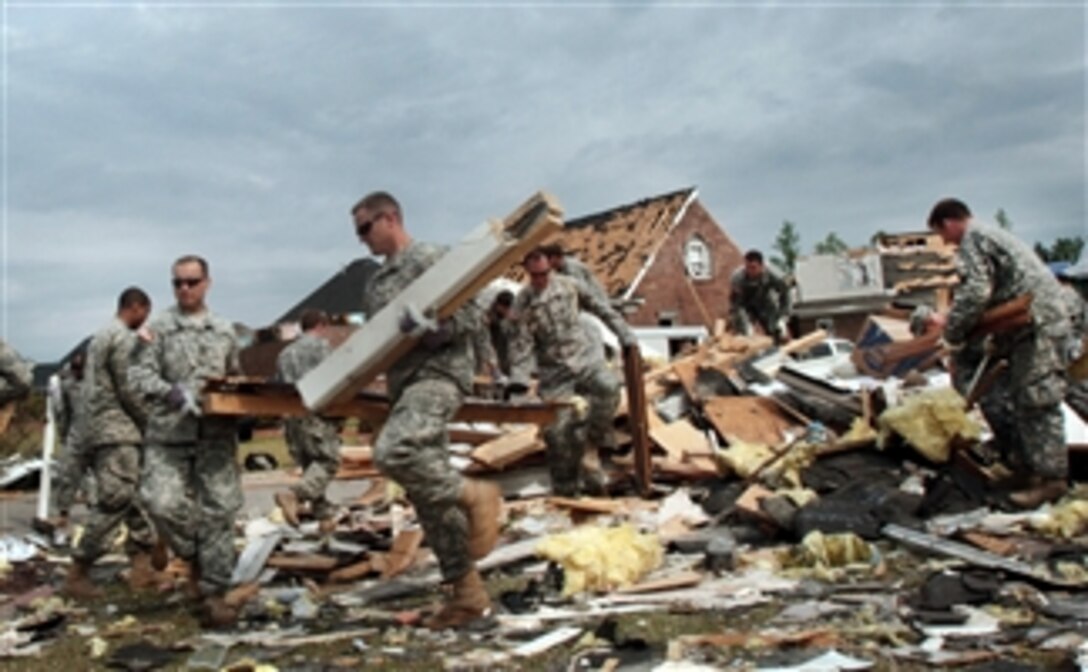 Approximately 50 U.S. soldiers from the U.S. Army John F. Kennedy Special Warfare Center and School at Fort Bragg, N.C., assist in the cleanup of a Fayetteville, N.C., neighborhood on April 21, 2011.  The neighborhood was damaged by tornadoes on April 16, 2011.  The soldiers, mainly comprised of recent Special Forces qualification course graduates, spent the morning sorting through debris and placing it in piles for pickup by the city.  