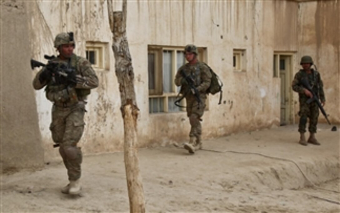U.S. and Afghan National Army soldiers move toward their objective during a cordon and search operation in Nani, Afghanistan, on March 29, 2011.  