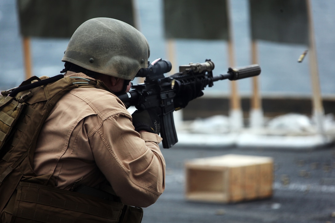 A Marine with the 22nd Marine Expeditionary Unit fires on a target during a combat marksmanship training exercise aboard USS Bataan, April 22, 2011.  Marines and sailors with the 22nd MEU’s Force Reconnaissance, Radio Reconnaissance and Intelligence sections fired on silhouette targets positioned on the ship’s edge.  The Marines and sailors of the 22nd MEU are currently deployed with Amphibious Squadron 6 aboard USS Bataan Amphibious Ready Group and will continue to train and improve the MEU’s ability to operate as a cohesive and effective Marine Air Ground Task Force.  The 22nd MEU is a multi-mission, capable force comprised of an Aviation Combat Element, Marine Medium Tilt Rotor Squadron 263 (Reinforced); a Logistics Combat Element, Combat Logistics Battalion 22; a Ground Combat Element, Battalion Landing Team, 2nd Battalion, 2nd Marine Regiment; and its Command Element. (Official U.S. Marine Corps photo by Sgt. Josh Cox)