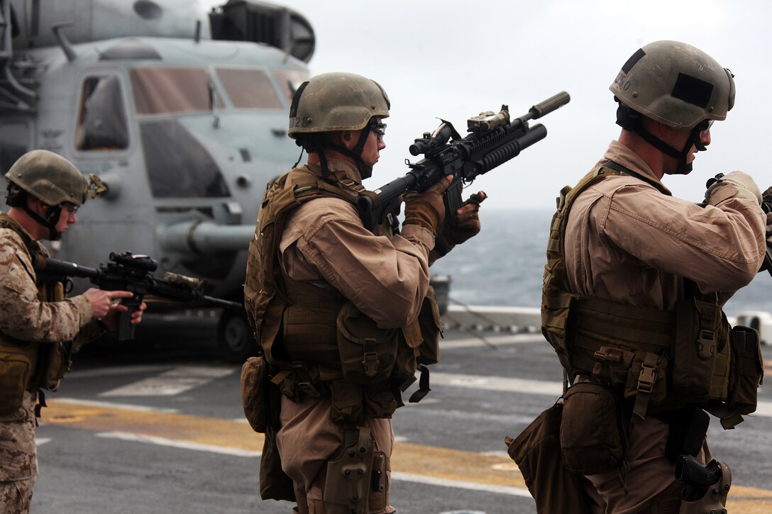 Marines and sailors with the 22nd Marine Expeditionary Unit load magazines into their weapons before firing on targets during a combat marksmanship training exercise aboard USS Bataan, April 22, 2011.  Marines and sailors with the 22nd MEU’s Force Reconnaissance, Radio Reconnaissance and Intelligence sections fired on silhouette targets positioned on the ship’s edge.  The Marines and sailors of the 22nd MEU are currently deployed with Amphibious Squadron 6 aboard USS Bataan Amphibious Ready Group and will continue to train and improve the MEU’s ability to operate as a cohesive and effective Marine Air Ground Task Force.  The 22nd MEU is a multi-mission, capable force comprised of an Aviation Combat Element, Marine Medium Tilt Rotor Squadron 263 (Reinforced); a Logistics Combat Element, Combat Logistics Battalion 22; a Ground Combat Element, Battalion Landing Team, 2nd Battalion, 2nd Marine Regiment; and its Command Element.