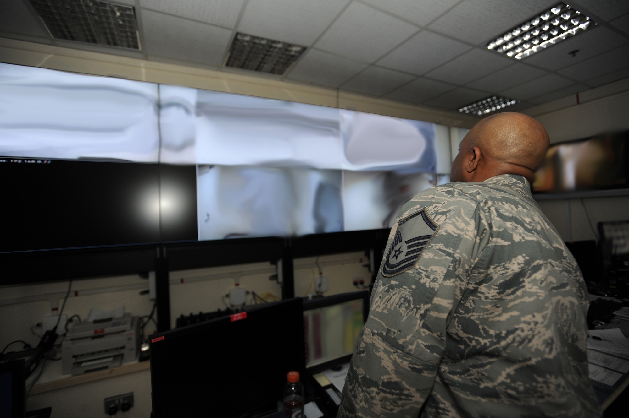 Master Sgt. Bradley Wooten revises Command Post displays with the most up to date wing information, keeping leadership aware of significant wing events. Command Post is the eyes and ears of the wing commander, providing flight following/mission monitoring, emergency management, coordination, and operational reporting to headquarters. Sergeant Wooten is deployed from the 60th Air Mobility Wing, Travis AFB, Calif. (U.S. Air Force photo by Senior Airman Maynelinne De La Cruz)