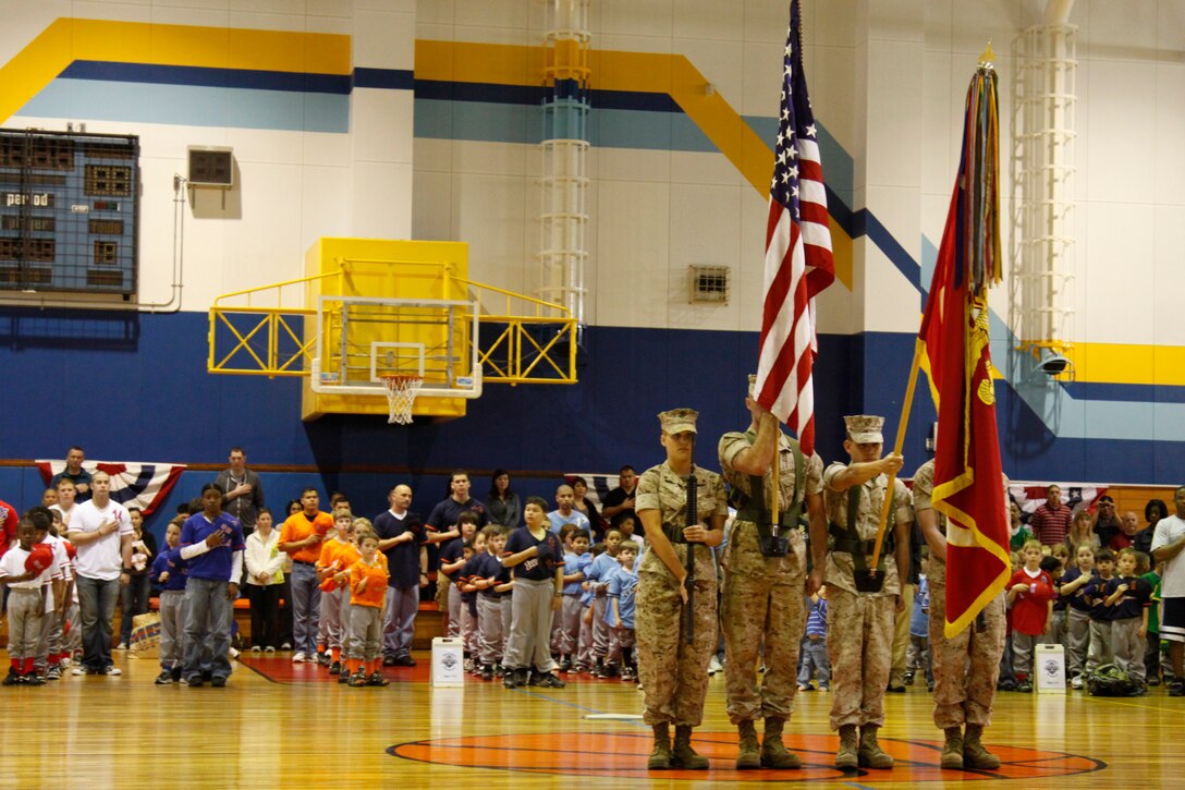 (LEFT TO RIGHT) Lance Cpl. Kristen F. Starkus, Sgt. Joshua R. Whitfield, Cpl. Christian A. Felix and Lance Cpl. Derrick J. Dzierzynski,  Marine Aviation Logistics Squadron 12 color guard, render honors during the youth baseball opening ceremony at the IronWorks Gym sports courts here April 23. The ceremony marked the start of the baseball season for children ages 5 - 13. Bob E. Johnston, Marine Corps Community Services deputy director, threw the first pitch of the season to officially signal the season’s start. Chaplain Anthony M. Baker offered a prayer for the players and coaches this season to offer guidance, instruction and safety.